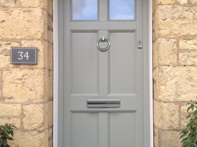 A grey/green residential front door.