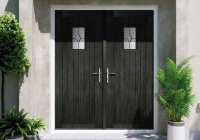 Black French composite doors opening into a home