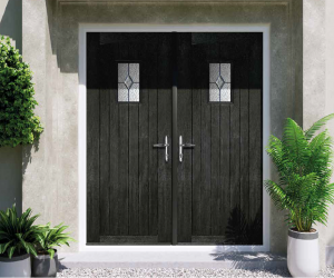 Black French composite doors opening into a home