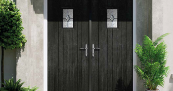 Black French composite doors opening into a home
