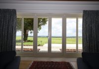 White timber French doors leading to outdoor patio