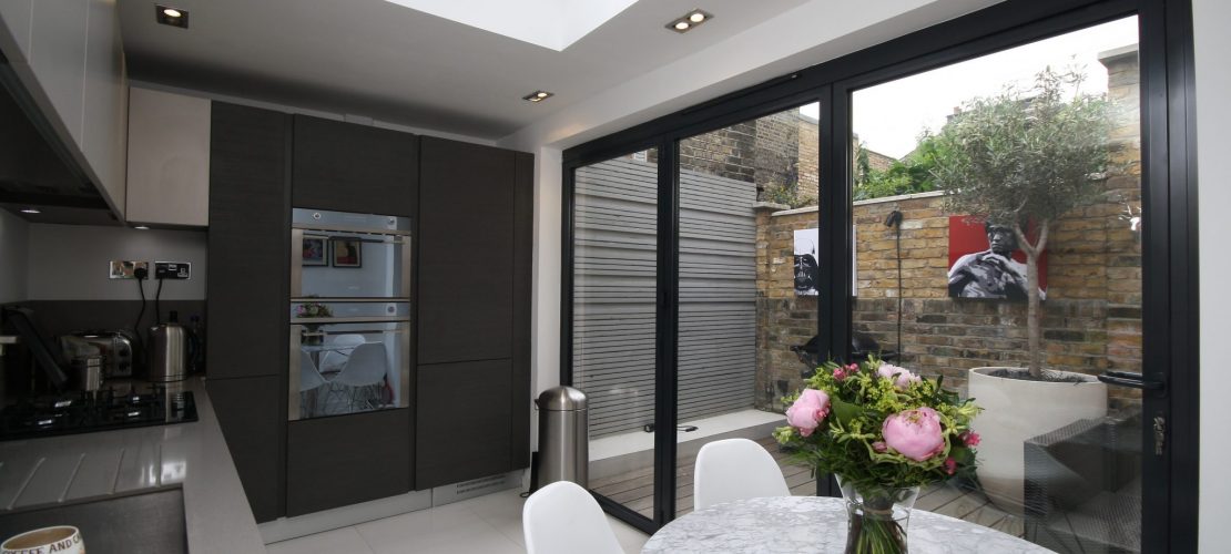 New modern black timber bifold doors in modern kitchen/diner space