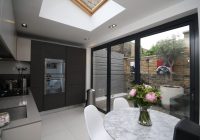 New modern black timber bifold doors in modern kitchen/diner space