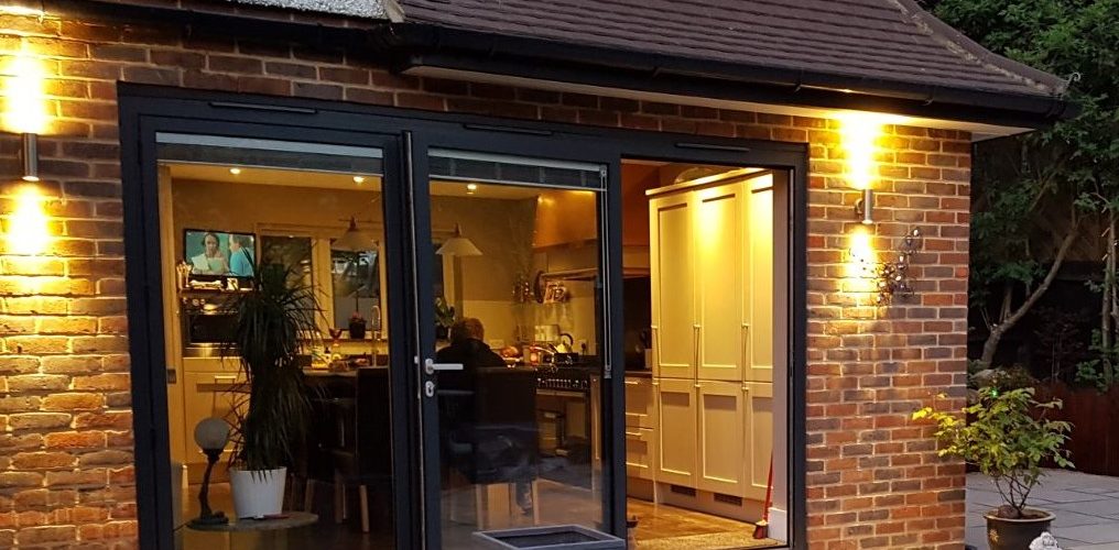 New bifold doors with outside lights opening onto patio