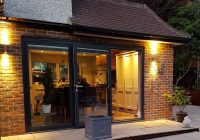 New bifold doors with outside lights opening onto patio