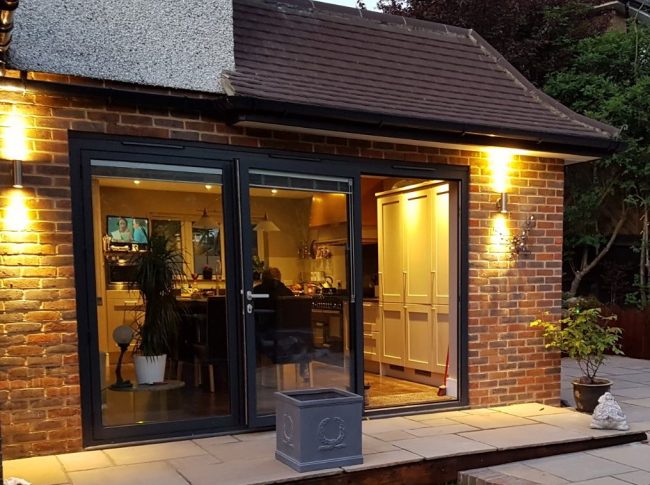New bifold doors with outside lights opening onto patio